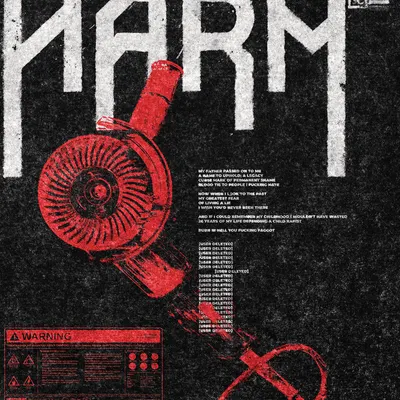 Close up of the tee print: the red angle grinder, its cord, and the warning label.